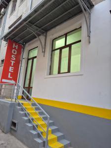 a stairway leading up to a building with a window at Miran Hostel in Andijan