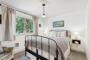 a bedroom with a bed and a window at Calm Waters in Rockaway Beach