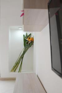 a flower in a vase on a wall at Trilogia Salentina x AP Apartment in Gallipoli