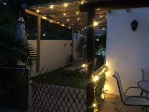 a patio with lights and a table and chairs at Villa Tranquilla in Estepona