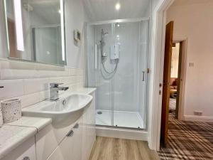 a bathroom with a shower and a sink at Lagoon View - Sea View- Pet Friendly - 2 Bed Apt - En-suite in Trearddur +31 photos