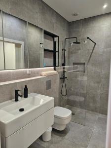 a bathroom with a sink and a toilet and a shower at City Center Terrace in Faro +32 photos