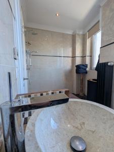 a bathroom with a sink and a shower in a room at Rooftop-Apartment Citylage in Offenburg +11 photos