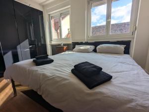 a bedroom with a large bed with two towels on it at Rooftop-Apartment Citylage in Offenburg