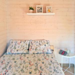 a bed with two pillows on it in a bedroom at Ostoja Wycinki domki letniskowe in Jaszczerz