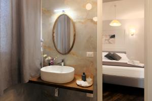 a bathroom with a sink and a bed at Verde Di Calabria in Palmi