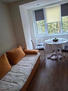 a living room with a couch and a table at Apartment Relax Chamkoria Borovets in Borovets