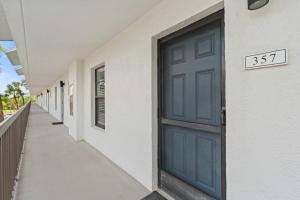a blue door on the side of a building at Luxury With Private Lanai Views and Close to the Pool in Naples