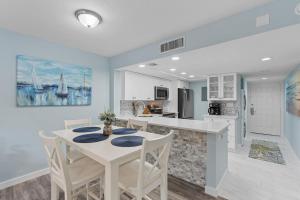 a kitchen and dining room with a table and chairs at Luxury With Private Lanai Views and Close to the Pool in Naples