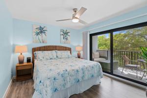 a bedroom with a bed and a balcony at Luxury With Private Lanai Views and Close to the Pool in Naples