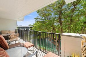 a balcony with a view of a swimming pool at Luxury With Private Lanai Views and Close to the Pool in Naples