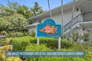 a sign for a hotel in front of a building at Luxury With Private Lanai Views and Close to the Pool in Naples