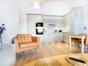 a living room with a chair and a table at Beautiful Loft Apartment City Centre in Belfast