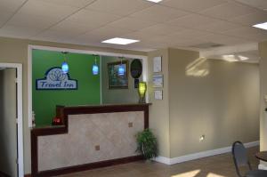 a waiting room with a travel inn sign on the wall at Travel Inn Kingsport in Kingsport