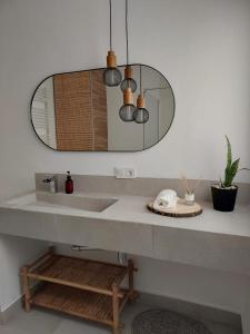 a bathroom with a sink and a mirror at Casa tía Satur in Consuegra
