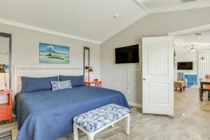 a bedroom with a blue bed and a chair at 2 Blocks From Aransas Bay Family Home with Patio! in Fulton