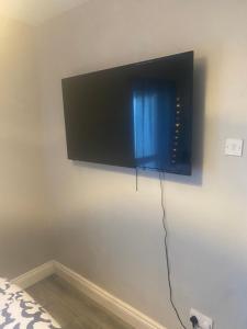 a flat screen tv hanging on a wall at Station Road 3 bed semi detached in Belfast