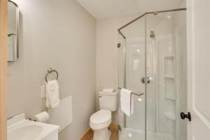 a white bathroom with a shower and a toilet at Close to Trails Studio with Water Views in Wurtsboro