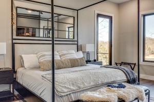 a bedroom with a large bed with a mirrored headboard at Lakefront Gem Dock and Hot Tub in Jacksboro in Jacksboro +33 photos