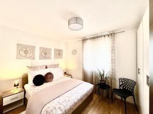 a bedroom with a bed and a chair and a window at Apartments Terra Solaris in Medulin