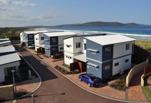 a car parked in front of a row of houses at BIG4 Middleton Beach Holiday Park in Albany