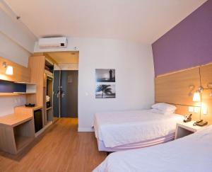 Stay Inn Santos Sua acomodação com cara de Hotel客房内的一张或多张床位