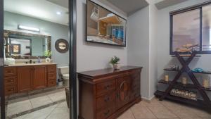 a bathroom with a wooden dresser and a sink at Las Palomas Beach & Golf Resort in Puerto Peñasco