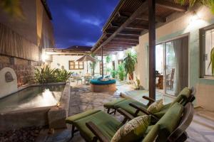 a patio with a pool and chairs and a house at Casa Abuelita: An exquisite, historic La Paz home in La Paz