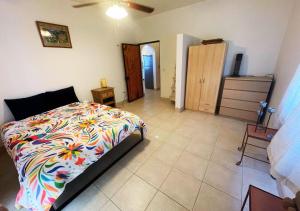a bedroom with a bed with a colorful comforter at Desert Oasis in El Dorado Ranch - San Felipe Resort Rental Home in Playa El Paraíso +25 photos