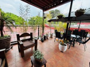 a patio with a table and chairs and an umbrella at Hotel Chilero Y Café in Antigua Guatemala