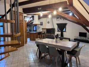 a kitchen and dining room with a table and chairs at Spacieux 120 metres carré tout confort in Grandvillars