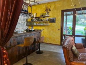 a bar with a couch and a chair in a room at Raggiale B&B in San Silvestro