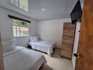 A bed or beds in a room at Hotel Diego Pacho