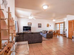 a living room with a couch and a tv at Casa Tilly El Dorado Ranch San Felipe Rental Home in Playa El Paraíso