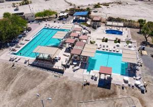 an overhead view of a large swimming pool with chairs at Casa Tilly El Dorado Ranch San Felipe Rental Home in Playa El Paraíso