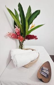 a vase filled with flowers on a table with a towel at Casa Tortuga in El Valle