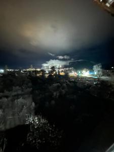 a view of a city at night with lights at Archontiko Brides of Meteora in Kalabaka