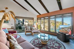 a living room with a couch and a tv at 130MT 130 Middle Terrace in Avalon