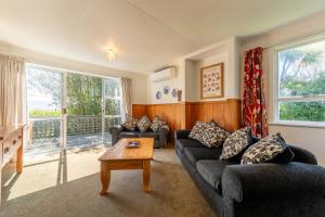 a living room with two couches and a coffee table at Private, Peaceful, Handy Location - KK7832 in Kaikoura