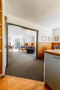 a living room with a couch and a table at Private, Peaceful, Handy Location - KK7832 in Kaikoura