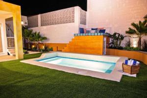 a swimming pool in the middle of a yard at walk to malecón, private Pool and Garden in La Paz