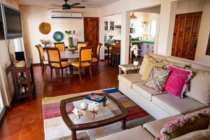 a living room with a couch and a table at walk to malecón, private Pool and Garden in La Paz