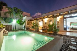 a swimming pool in the backyard of a house at private Pool, walk to malecón, 2 BR estilo hacienda in La Paz