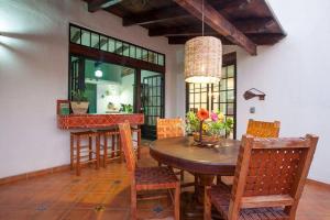 a dining room with a wooden table and chairs at private Pool, walk to malecón, 2 BR estilo hacienda in La Paz +20 photos