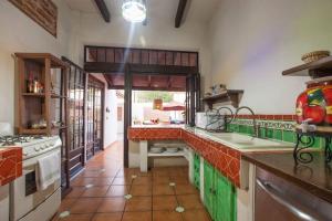 a kitchen with green cabinets and a counter top at private Pool, walk to malecón, 2 BR estilo hacienda in La Paz