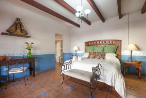a bedroom with a bed and a desk and a chair at private Pool, walk to malecón, 2 BR estilo hacienda in La Paz