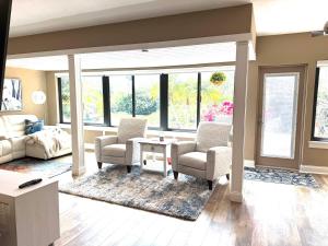 a living room with two chairs and a table at Sarasota Charm in Sarasota