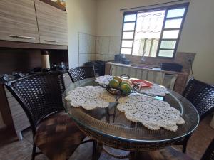 a dining room table with a bowl of fruit on it at Casa Para TECNOSHOW Comigo Rio Verde GO in Rio Verde