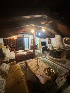 a bedroom with a bed and a table in a room at Archontiko Brides of Meteora in Kalabaka