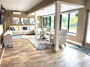 a living room with chairs and a table at Sarasota Charm in Sarasota
